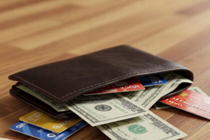 A wallet full of credit cards and cash