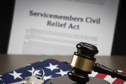 A judge's gavel and house keys rest on a folded American flag, symbolizing the Greystar settlement and the legal rights of servicemembers under the SCRA.